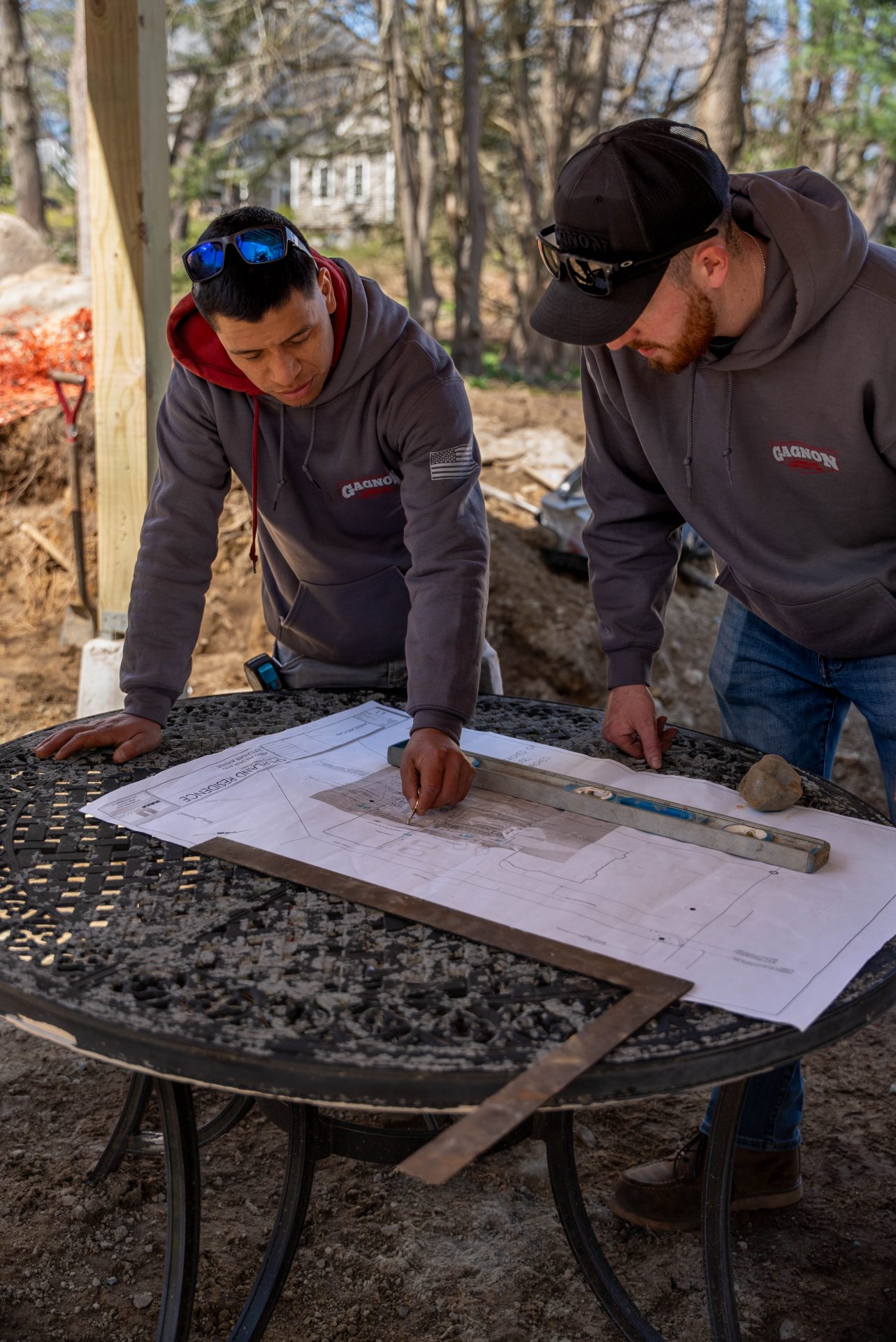 Construction workers reviewing blueprints at outdoor job site