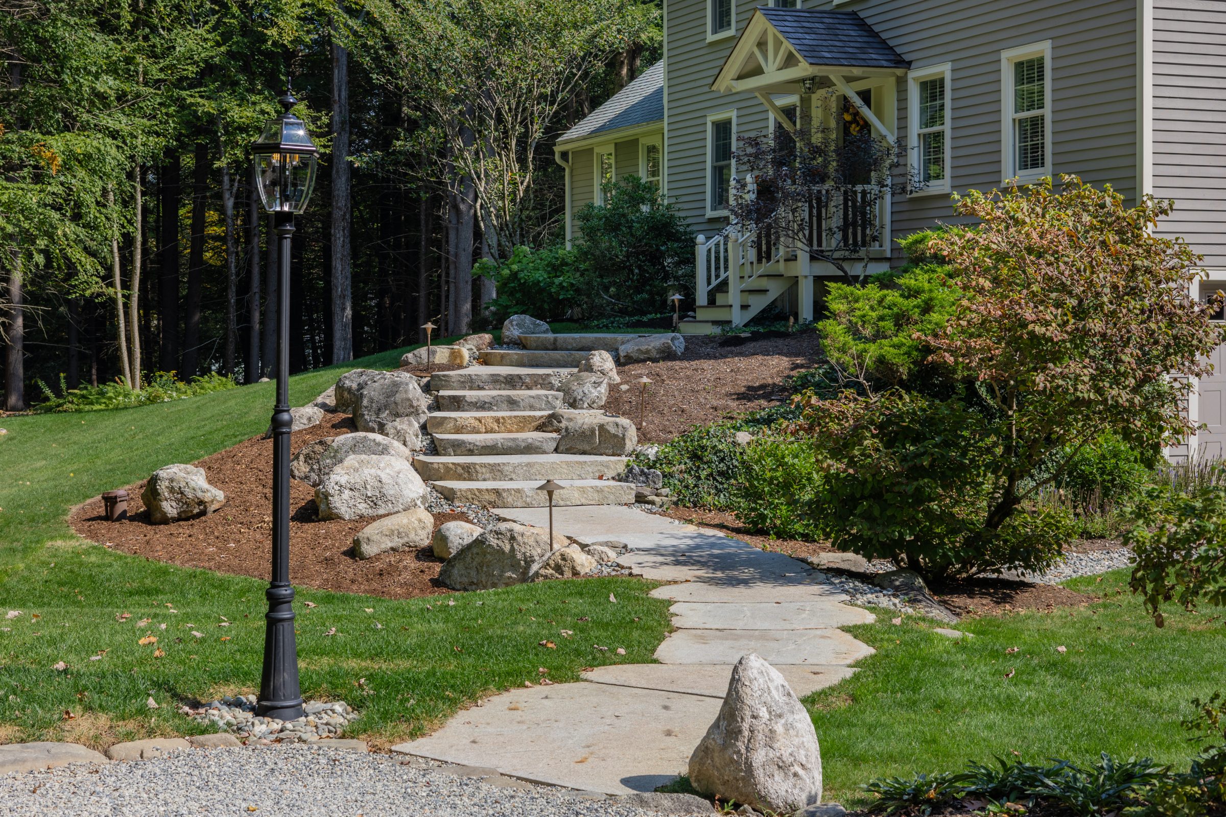 Stone steps leading to landscaped suburban home