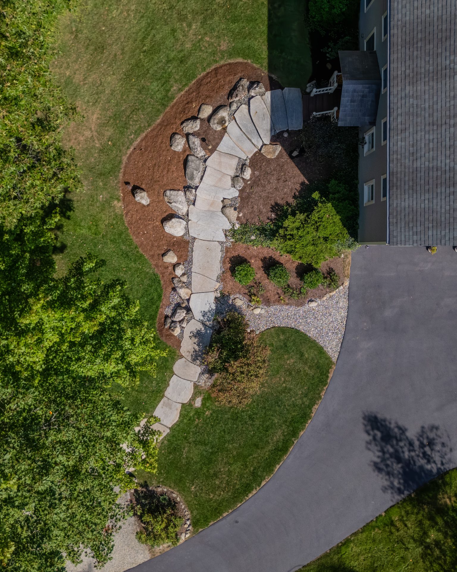 Aerial view of landscaped yard with stone walkway