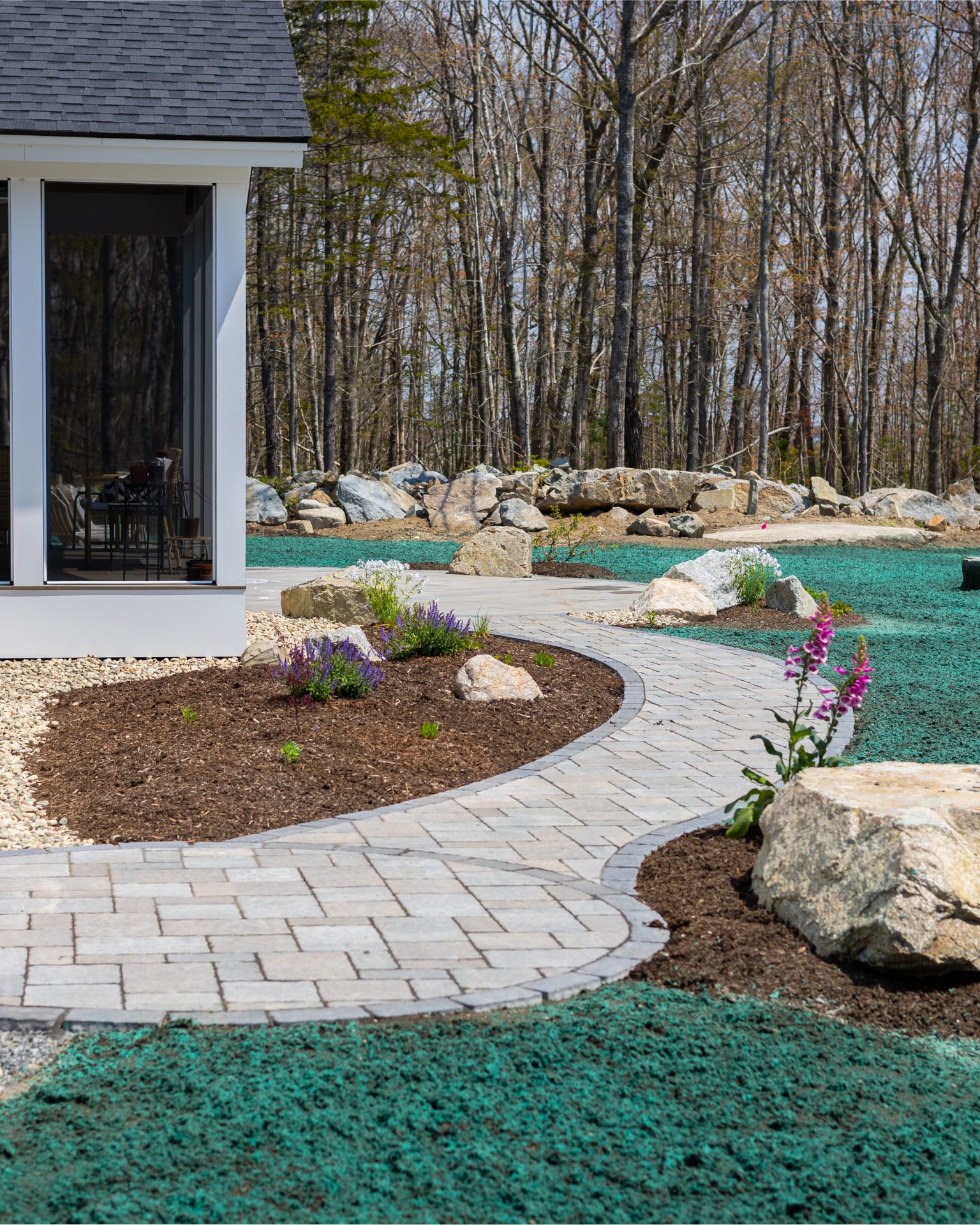 Curved stone walkway in landscaped backyard garden