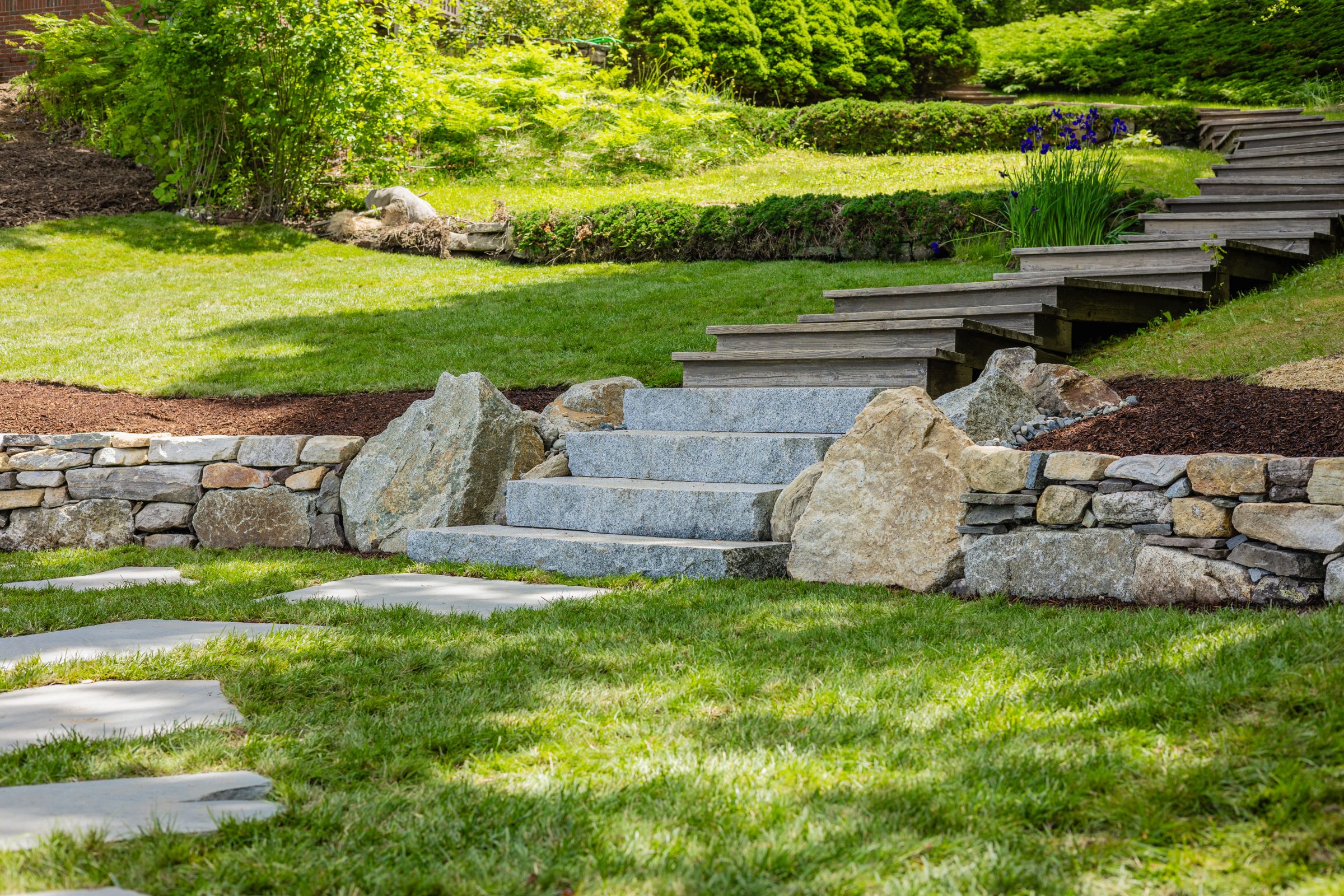 Stone steps and wooden stairs in landscaped garden