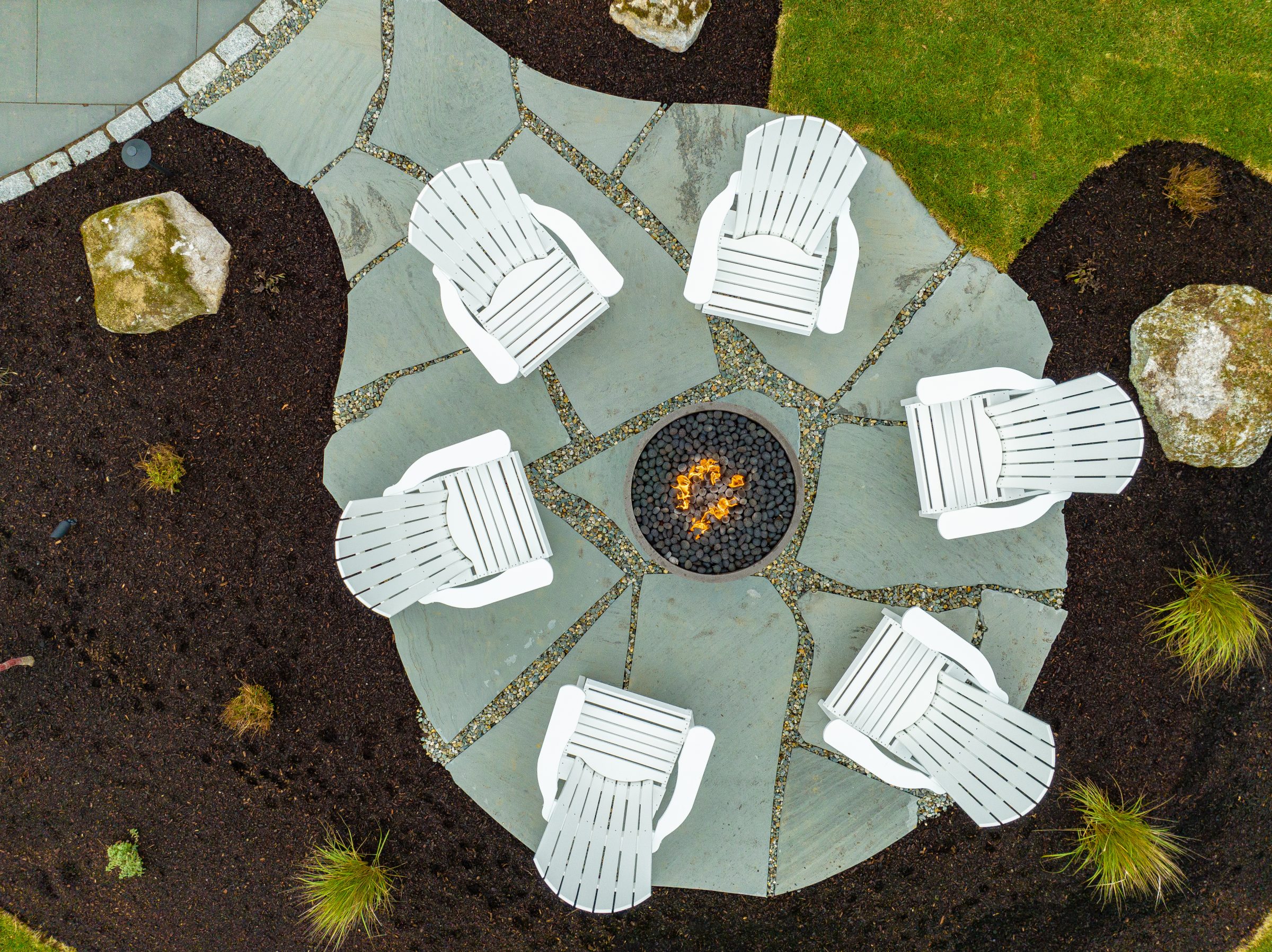 Aerial view of chairs around circular fire pit
