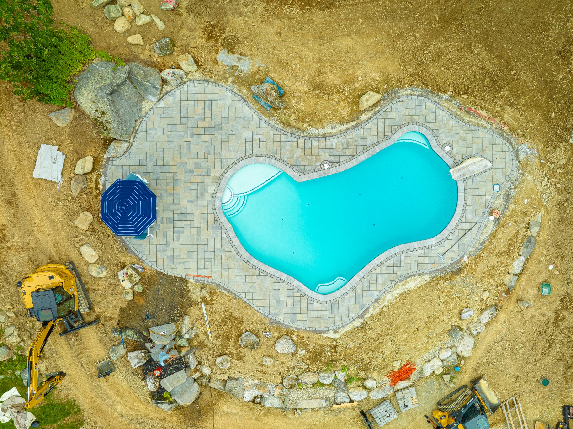 Aerial view of backyard pool under construction