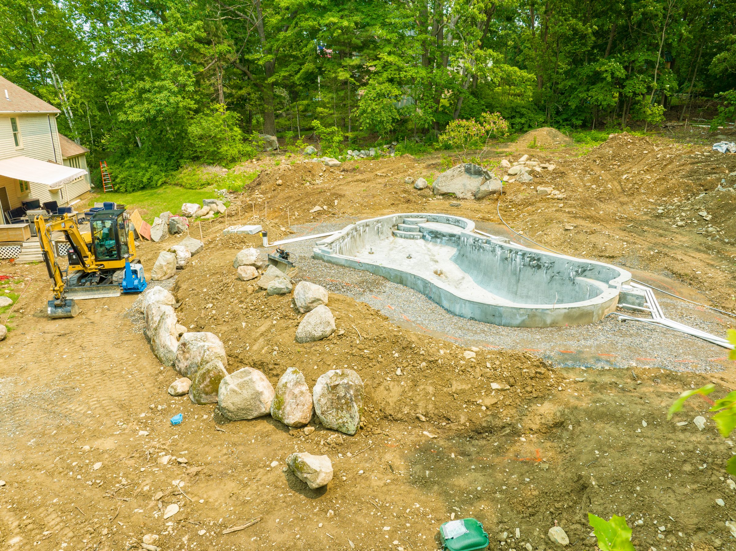 In-ground pool under construction in backyard