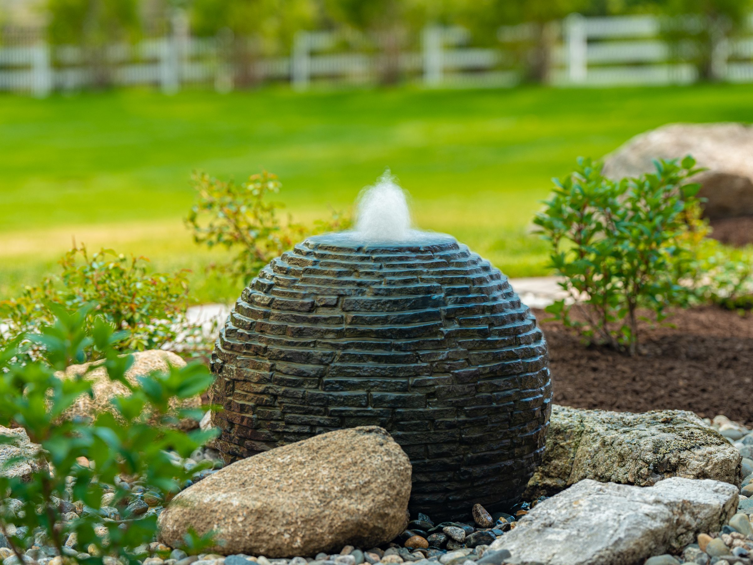Stacked stone garden fountain with bubbling water