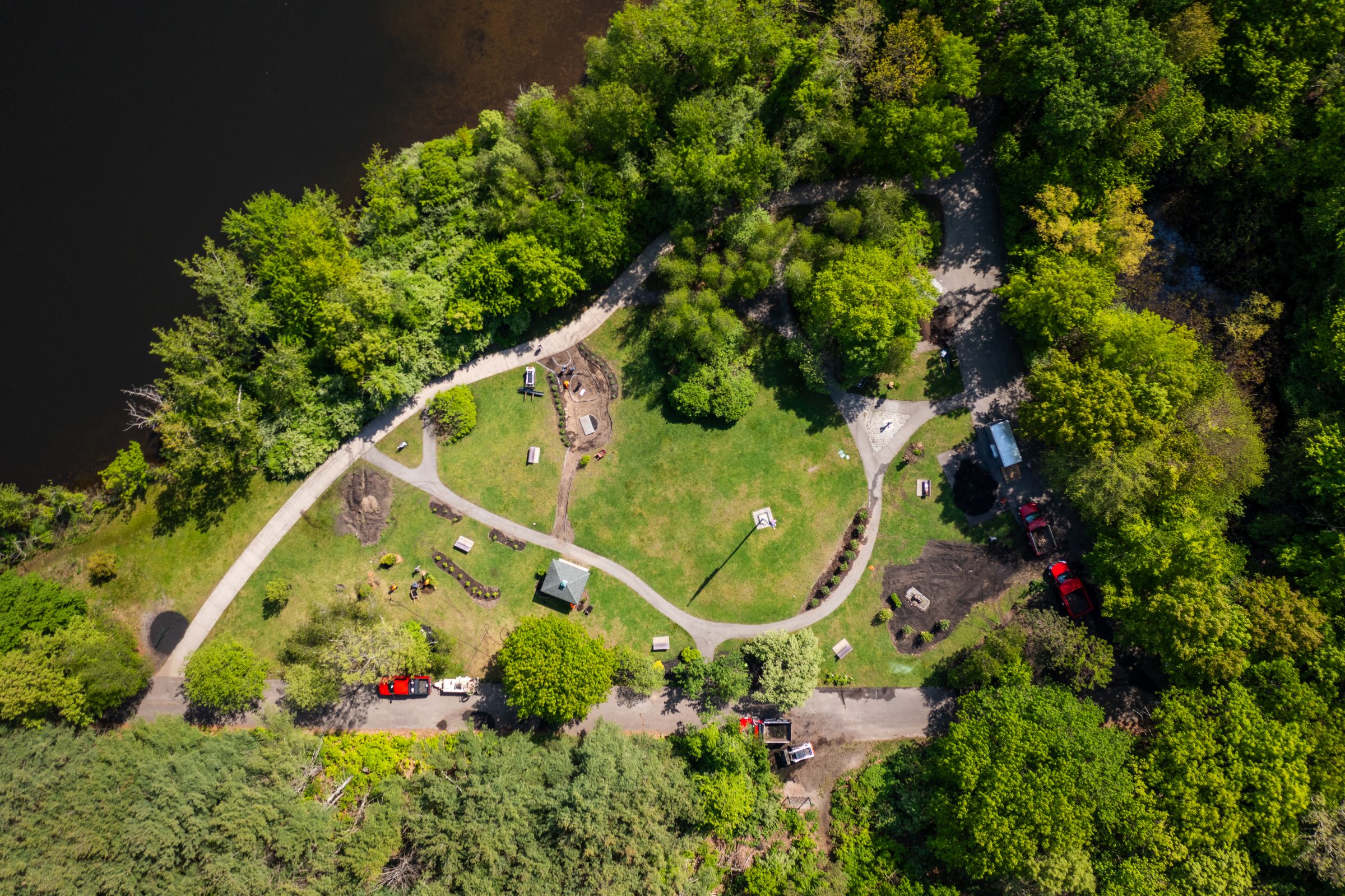 Aerial view of riverside park with winding paths