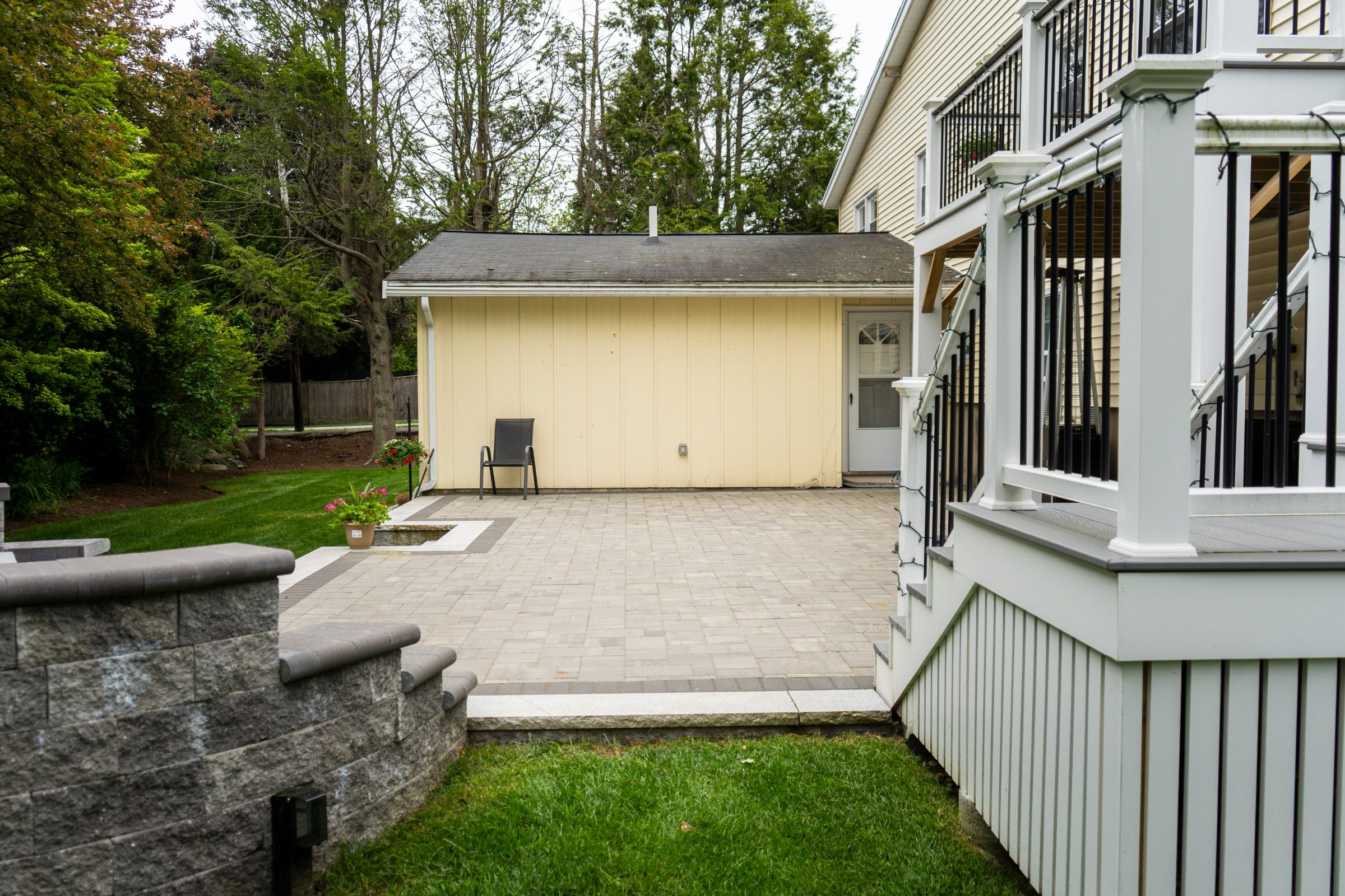 Backyard patio with stone pavers and small shed