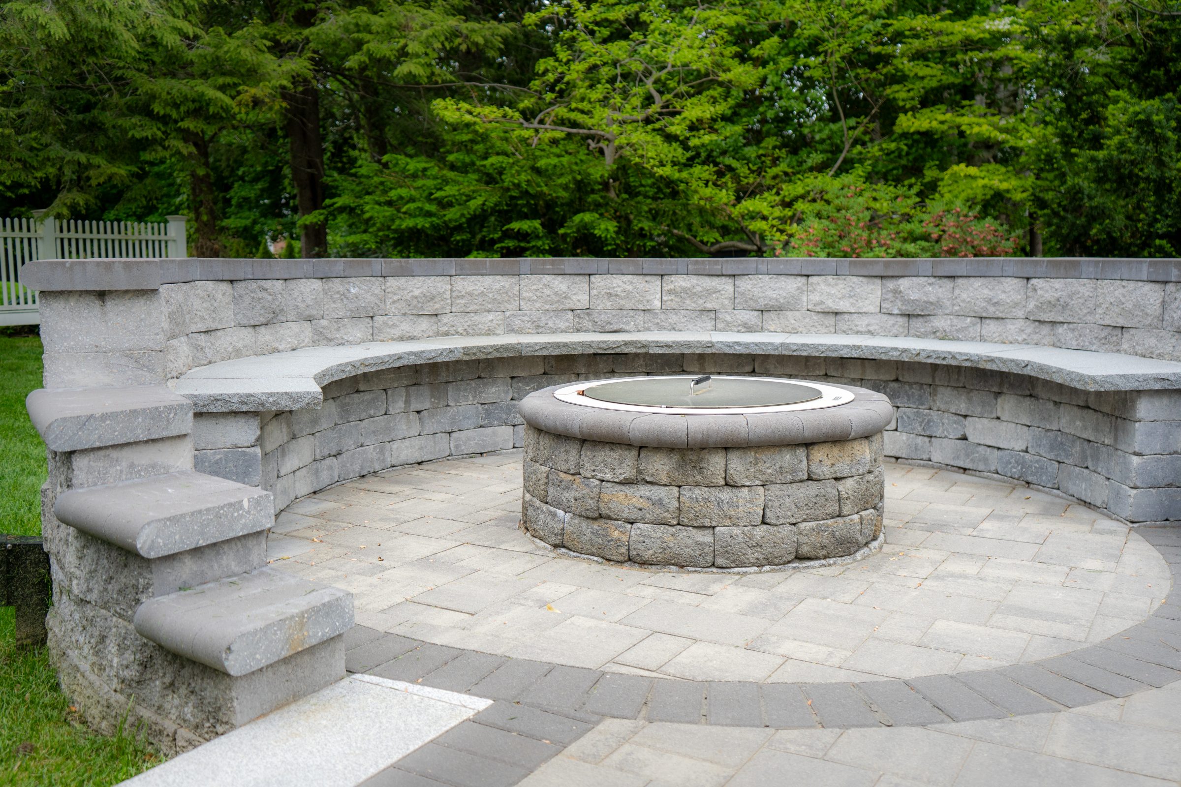 Stone patio with curved seating and fire pit