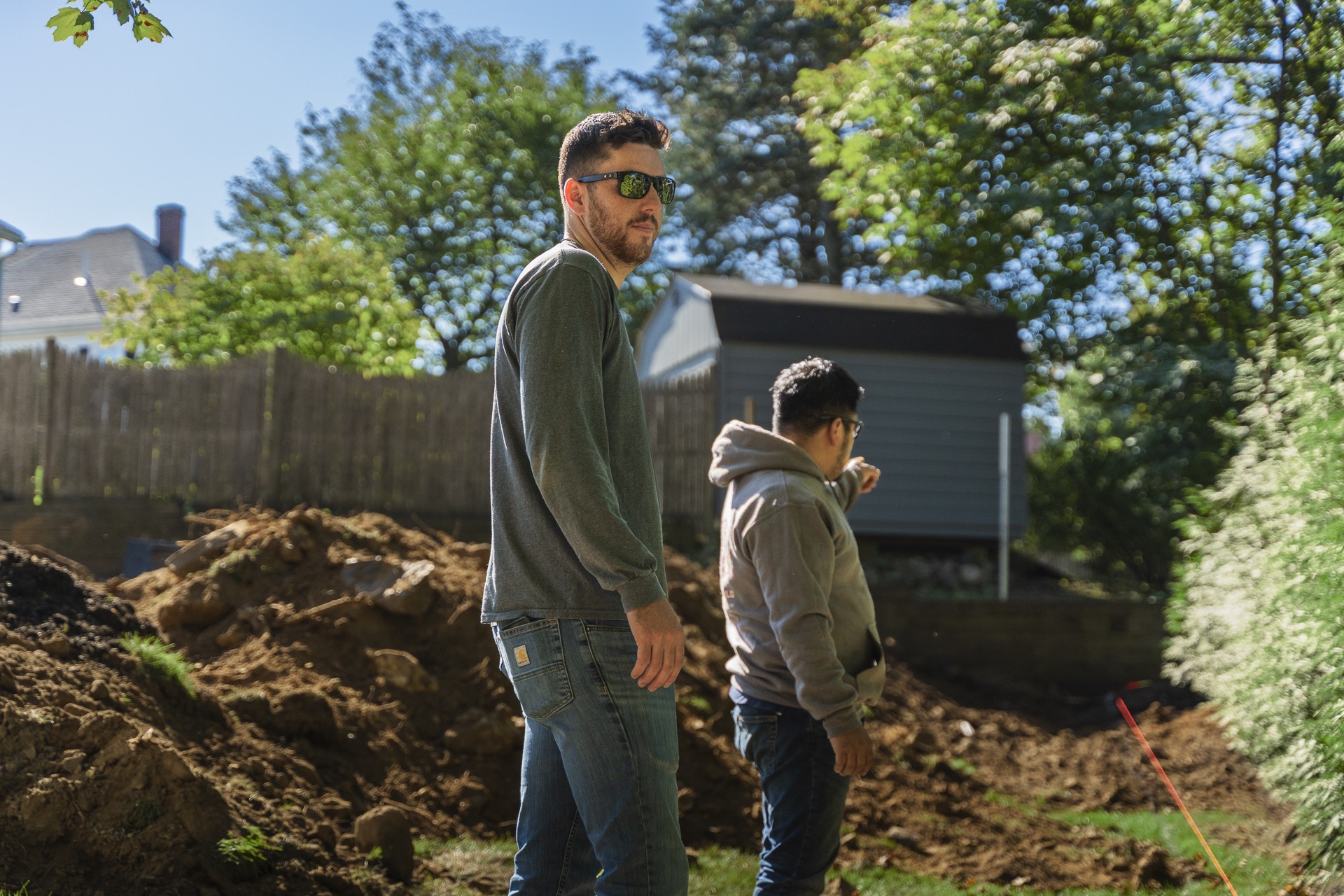 Two men inspecting backyard construction site
