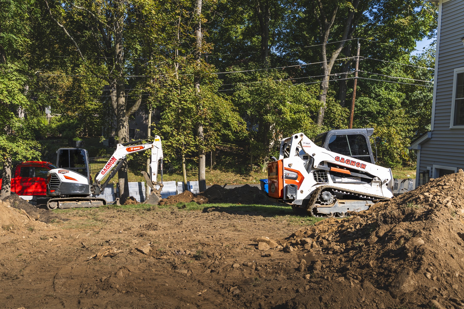 Excavator and skid-steer at residential construction site