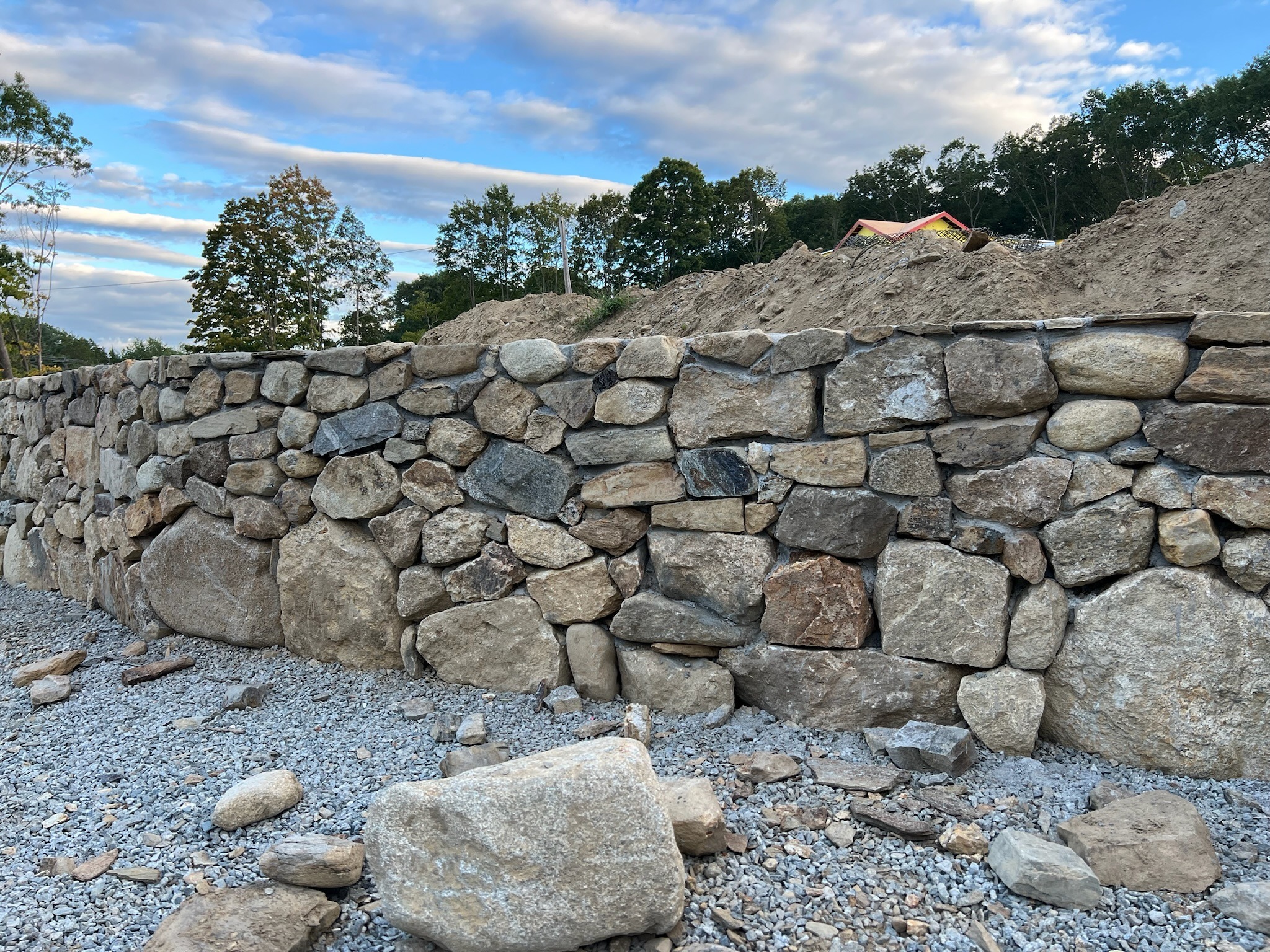 Stone retaining wall with gravel foreground