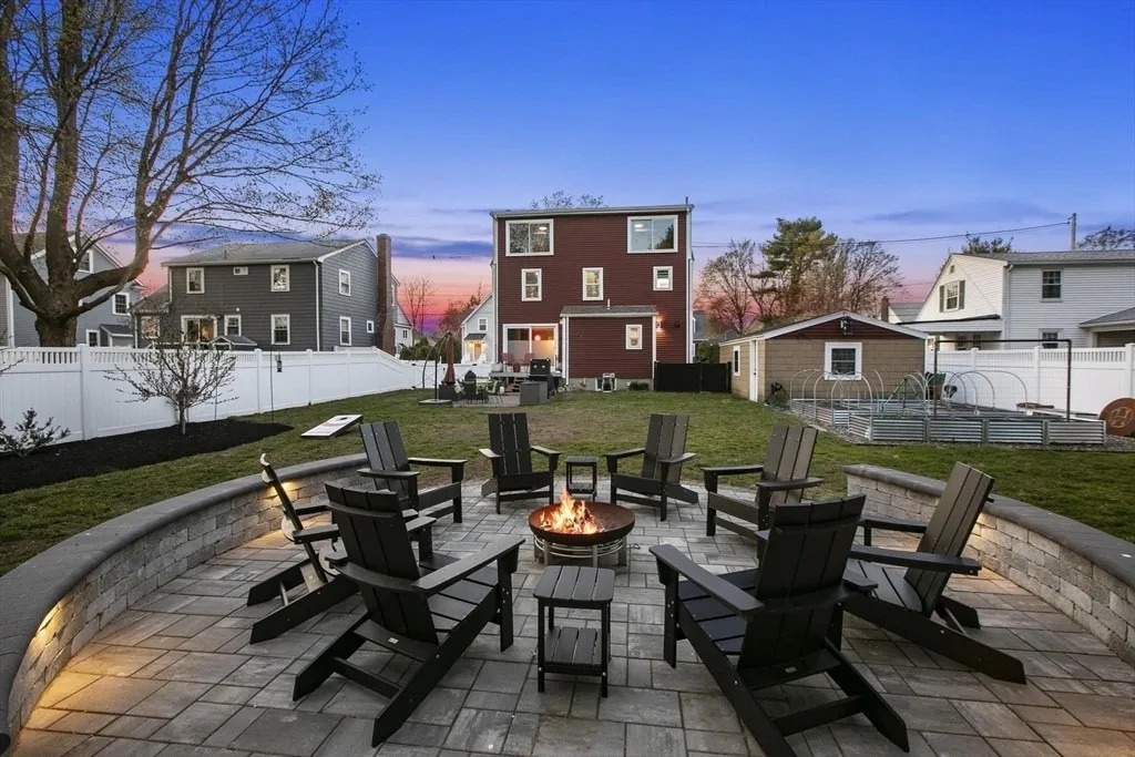 Backyard patio with fire pit at sunset