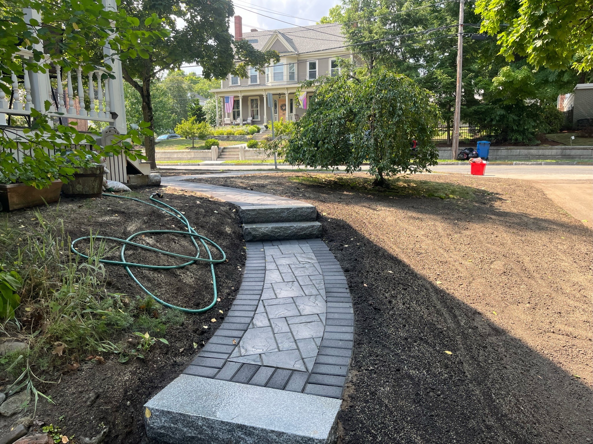 Curved stone walkway in freshly landscaped front yard