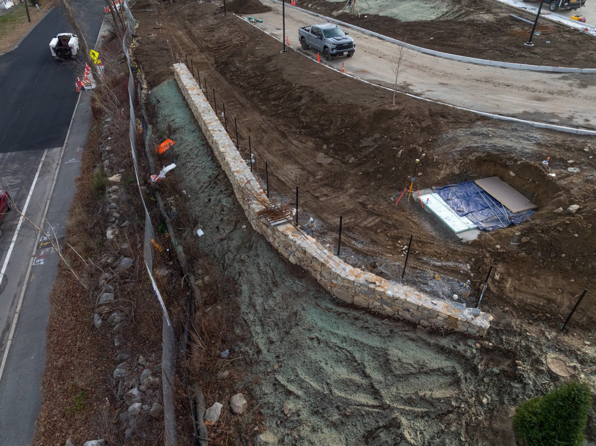 Aerial view of roadside construction and stone retaining wall