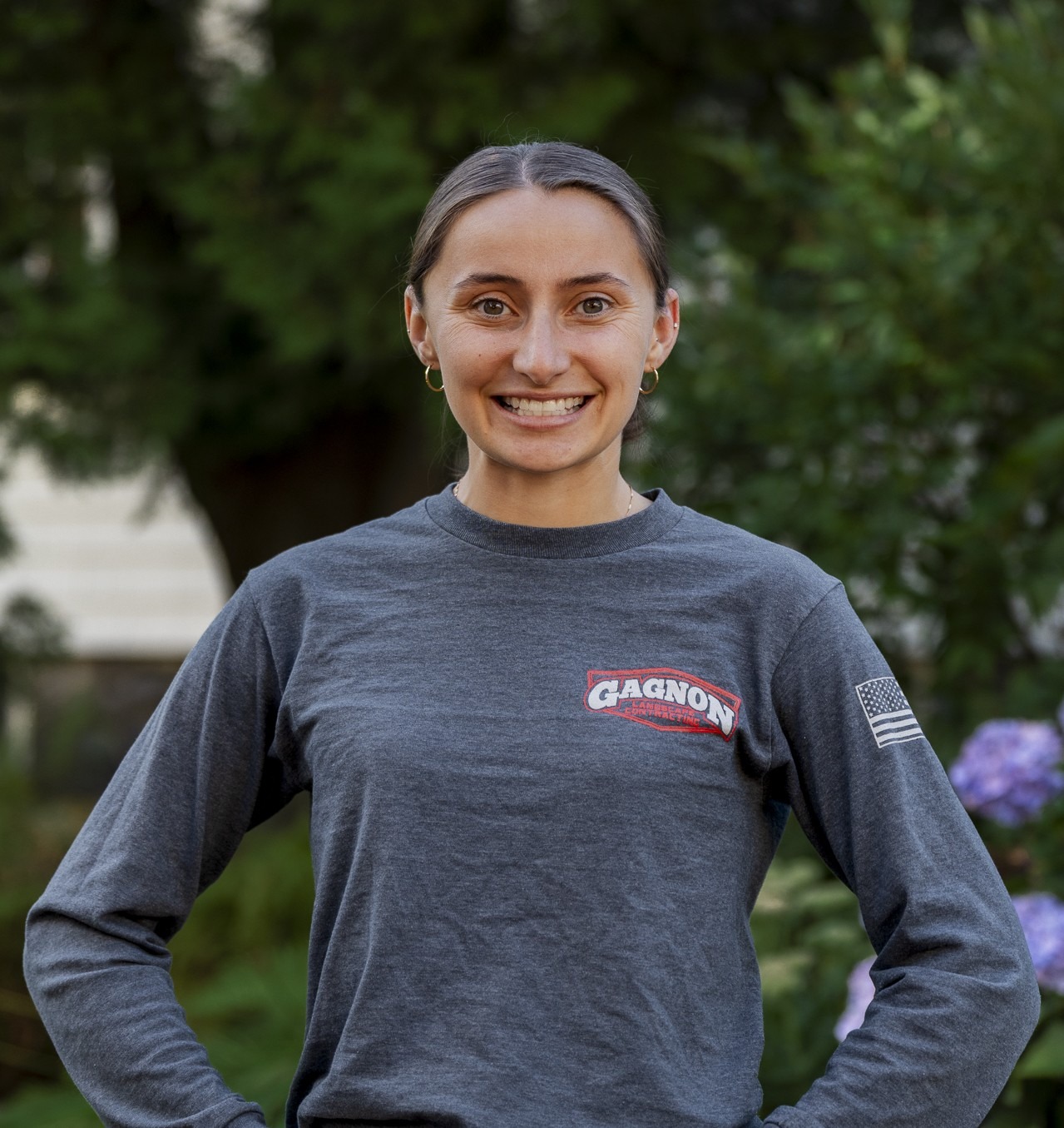 Smiling woman in gray shirt outdoors