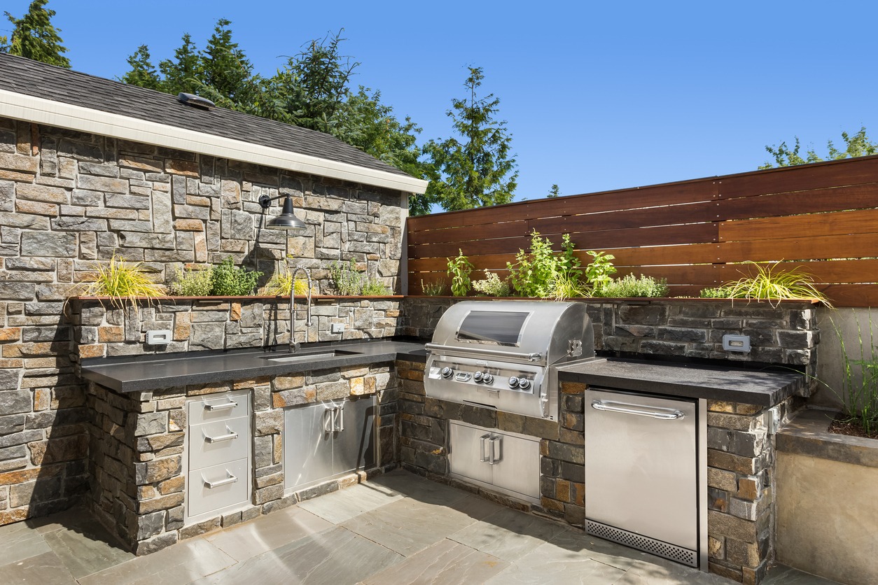 Modern outdoor stone kitchen with stainless steel grill