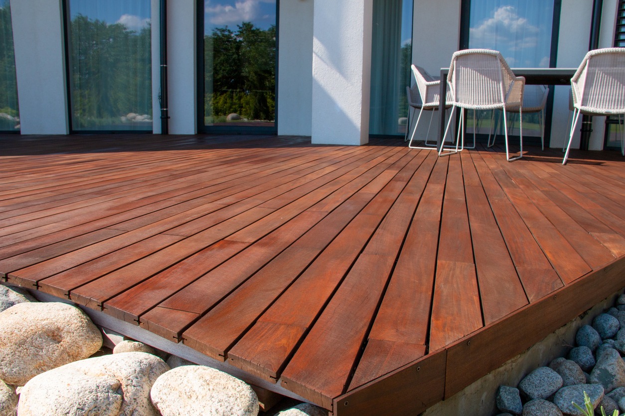 Modern wooden deck patio with outdoor dining set