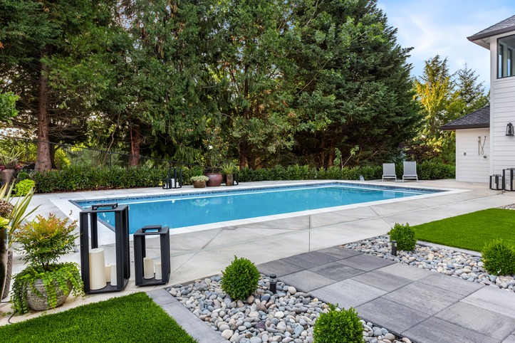 Modern backyard with rectangular swimming pool and patio