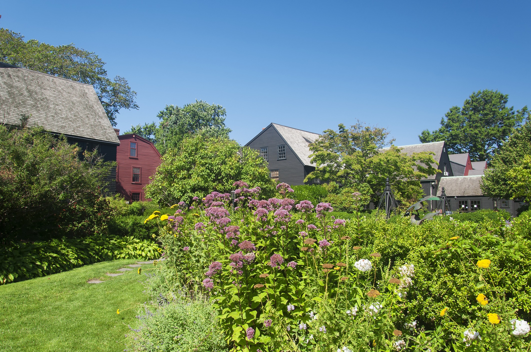 Colonial houses behind colorful blooming garden
