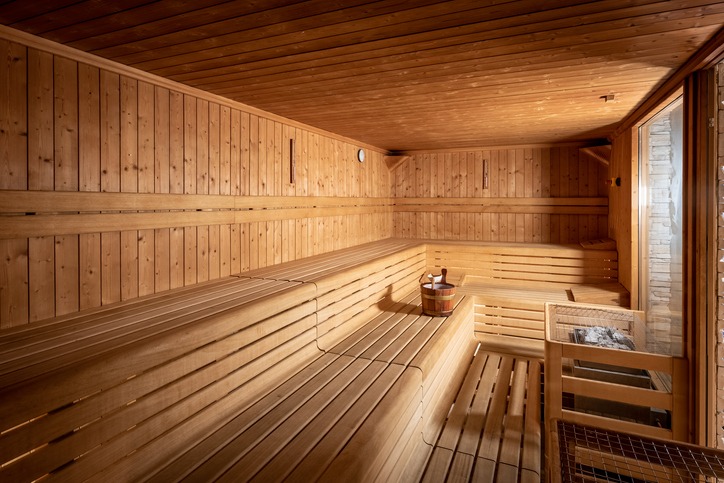 Spacious wooden sauna interior with tiered benches