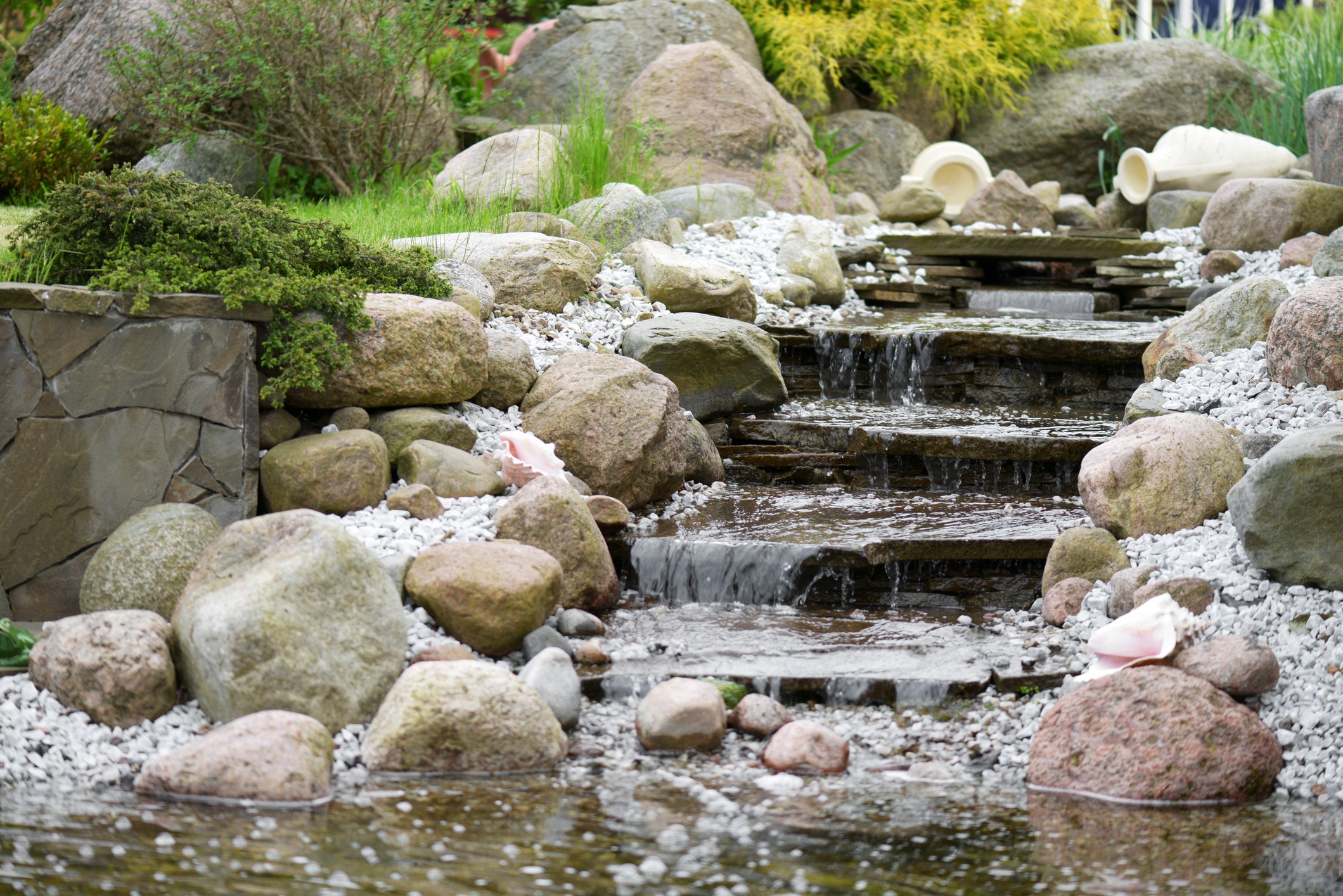 Stone garden waterfall with cascading stream